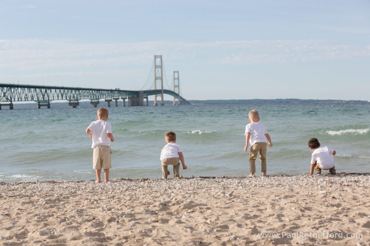 kids throwing rocks mackinac bridge photo