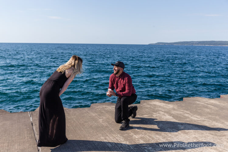 Surprise Engagement Petoskey Northern Michigan breakwall lighthouse Bayfront Park Photography