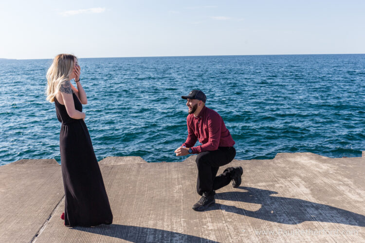 Surprise Engagement Petoskey Northern Michigan breakwall lighthouse Bayfront Park Photography