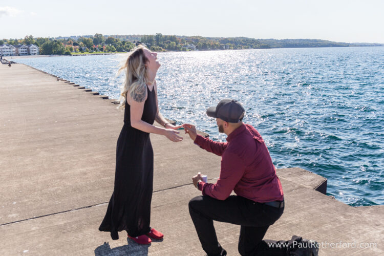Surprise Engagement Petoskey Northern Michigan breakwall lighthouse Bayfront Park Photography