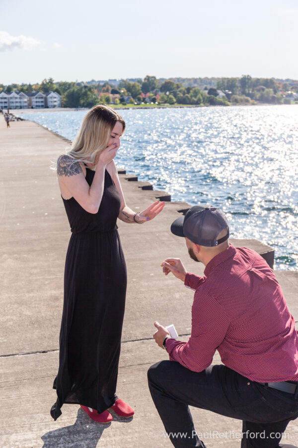 Surprise Engagement Petoskey Northern Michigan breakwall lighthouse Bayfront Park Photography