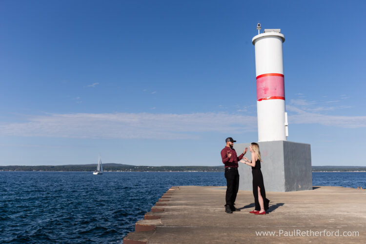 Surprise Engagement Petoskey Northern Michigan breakwall lighthouse Bayfront Park Photography