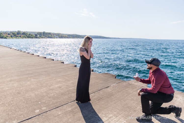 Surprise Engagement Petoskey Northern Michigan breakwall lighthouse Bayfront Park Photography